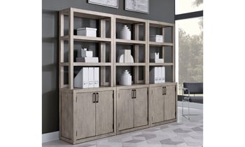 Wonderful display featuring three of the Platinum Gray Linen Bookcases with bottom cabinets.