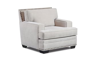 Cream-colored fabric upholstered arm chair with nail head trim.