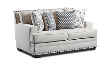 Plush loveseat in a cream colored fabric with four coordinating throw pillows.