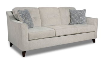 Harleston Cream Sofa with coordinating throw pillows and beige fabric upholstery.