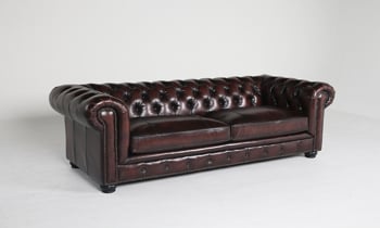 Traditional brown leather chesterfield sofa with nailhead trim.