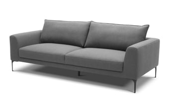 Neutral toned soffa with dark Gray throw pillows.