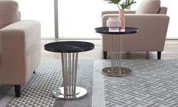 Round black marble top end table on a chrome base.
