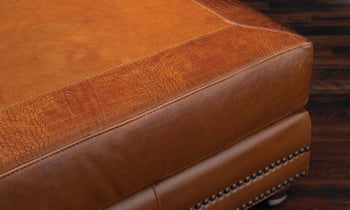 Closeup of alligator skin texture on 50-inch ottoman in cognac top-grain leather
