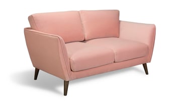 Pink velvet sofa in a living room.